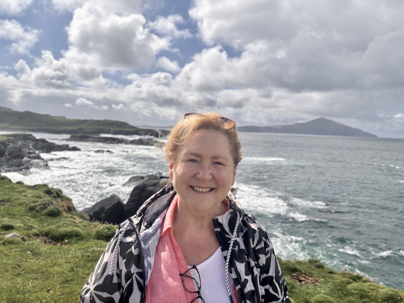 Carolyn on the Achill coast, the sea and mountains behind her.